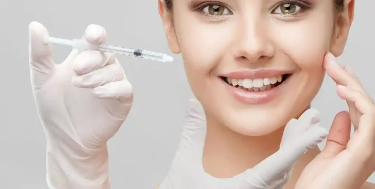 Woman touching smooth forehead after Botox treatment – illustrating results and typical Botox longevity